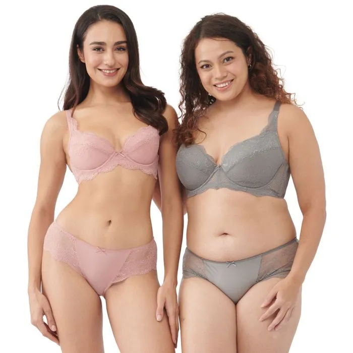 Two models in pastel pink and grey lace lingerie sets photographed in soft even daylight